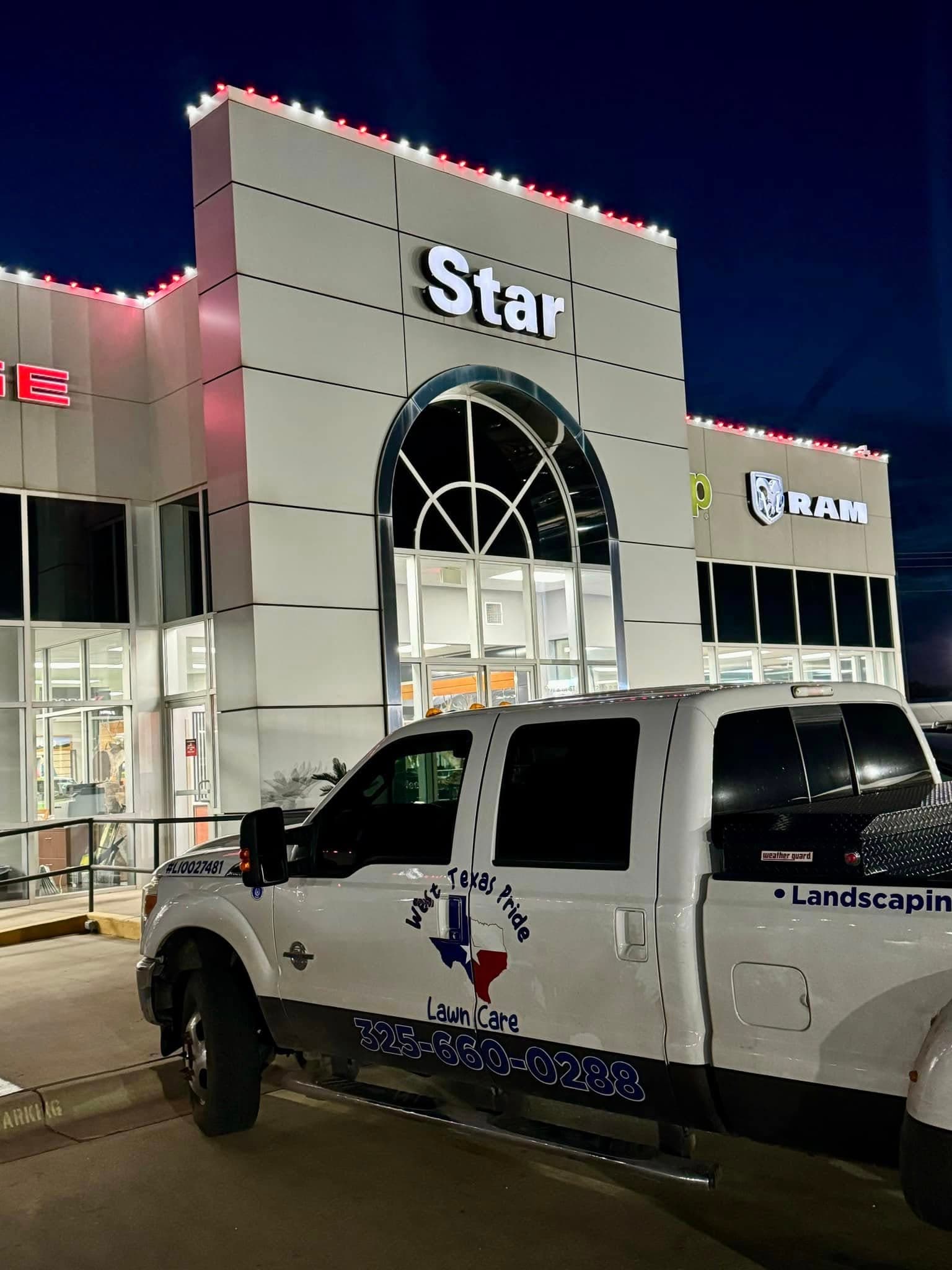 West Texas Pride branded truck at a commercial holiday-lighting jobsite